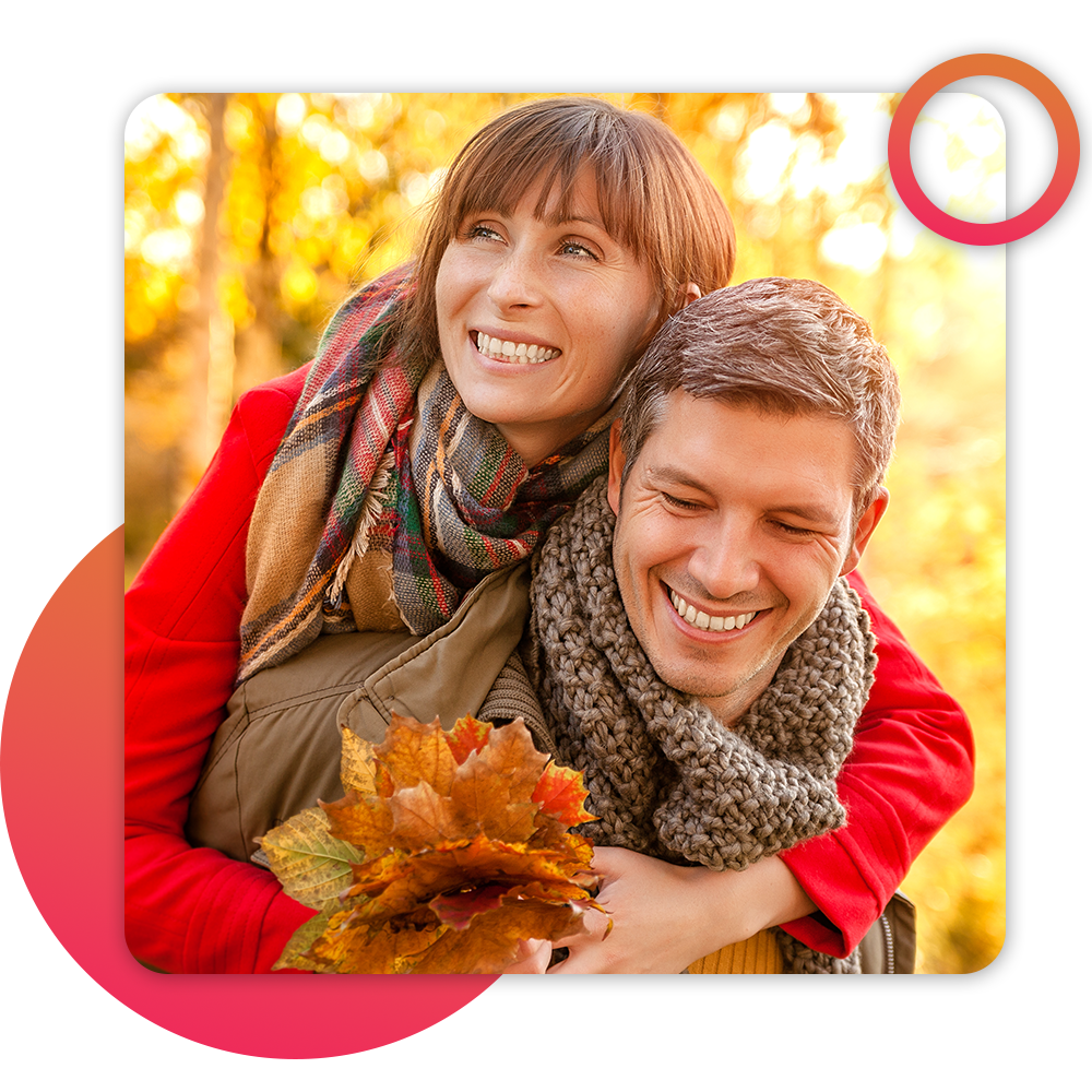 couple hugging, outdoors collecting fall leaves