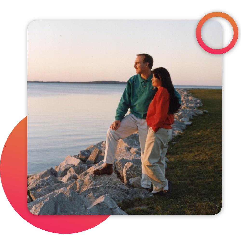 couple on beach watching sunrise/set