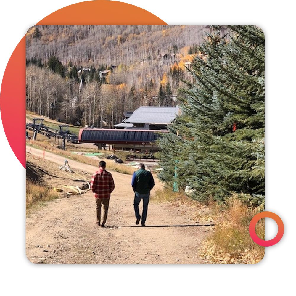 two people walking on rural road