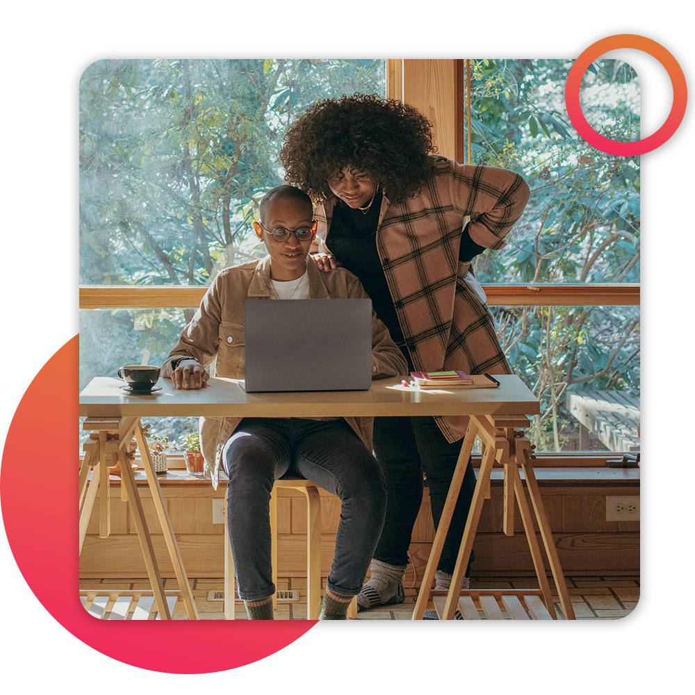 couple looking at computer at kitchen table