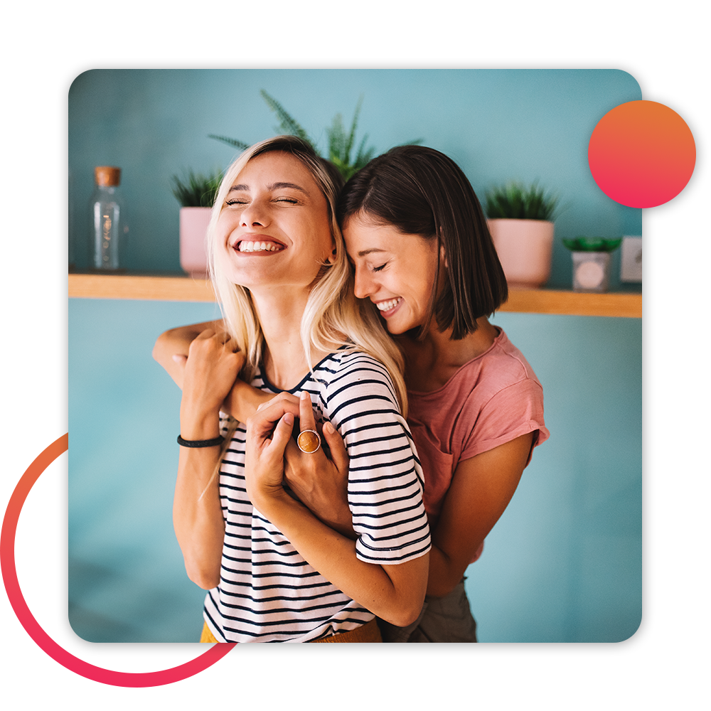 two women embracing each other in kitchen