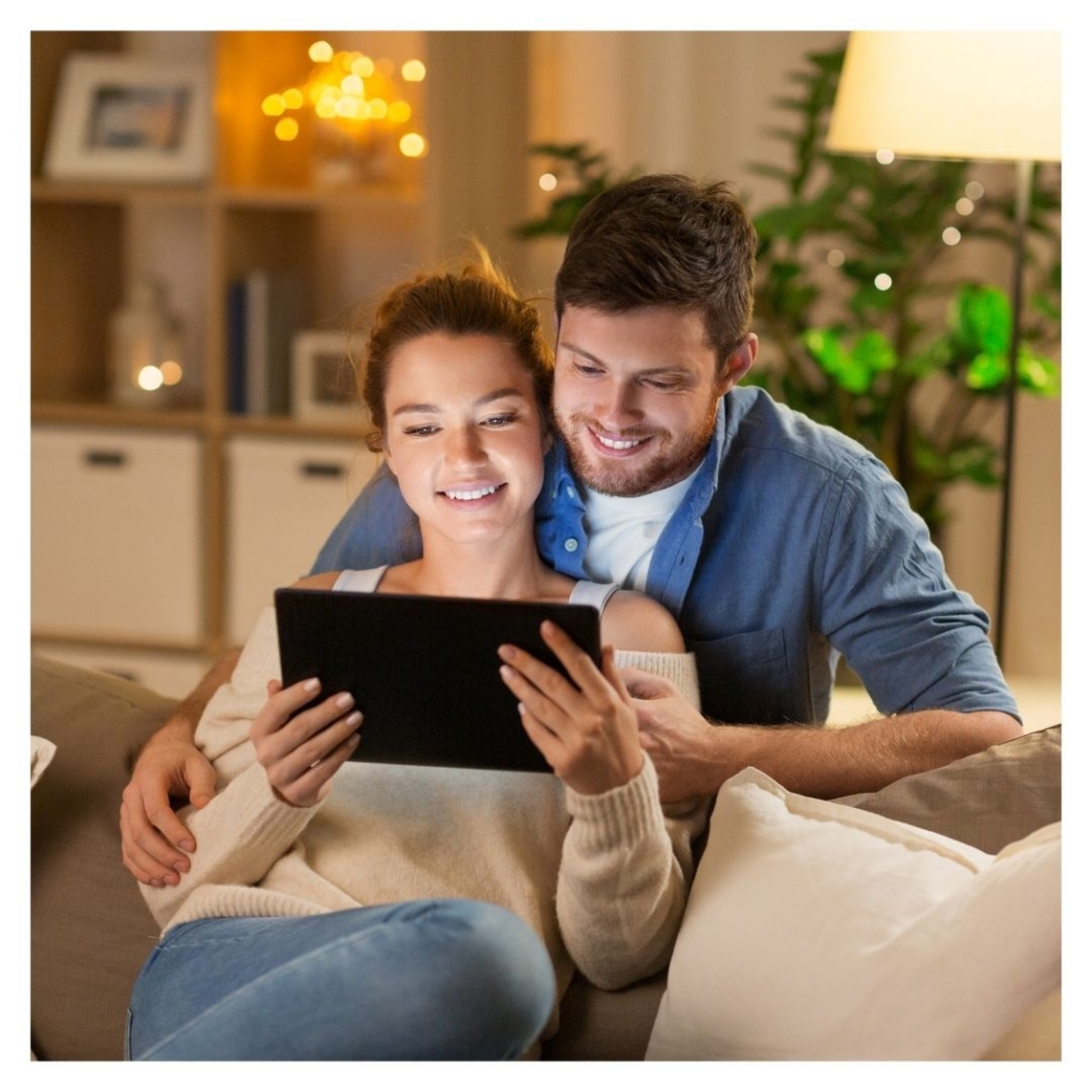 A couple looks at a tablet together