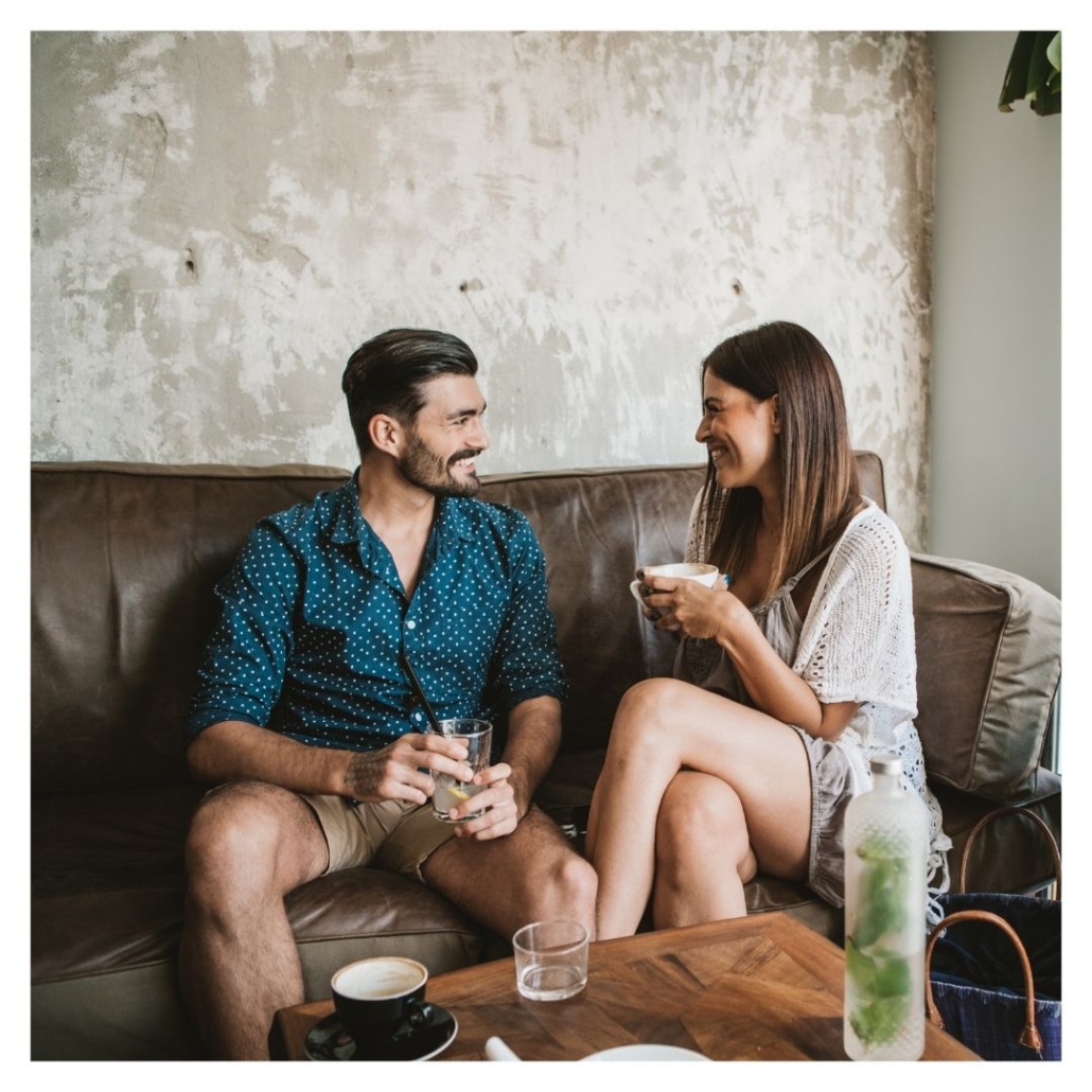 A couple on a date smiles together