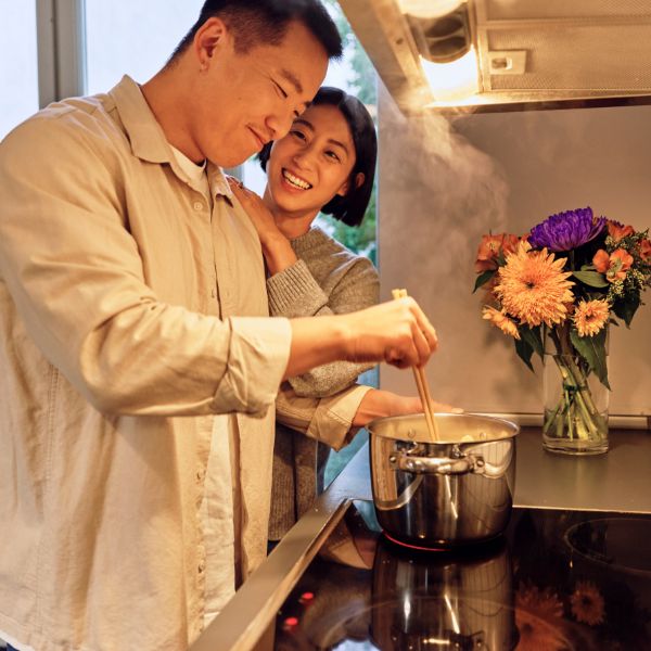 A couple cooking together.